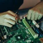close-up-photo-of-person-working-on-a-motherboard